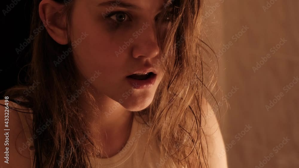 A girl suffering from a mental disorder. The girl is showing up taking drugs. A room with a blinking and broken light bulb. A girl suffering from a mental disorder. The girl is showing up taking drugs. A room with a blinking and broken light bulb.