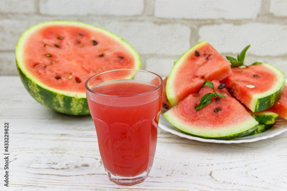 Glass of fresh watermelon juice on a white wooden table Glass of fresh watermelon juice on a white wooden table