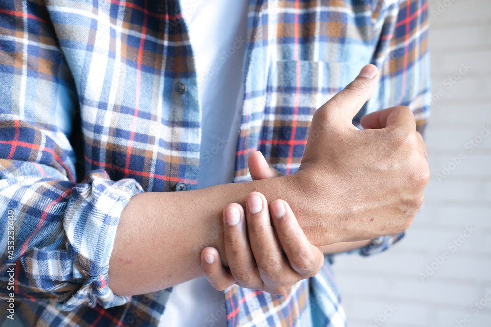 man suffering pain in hand close up man suffering pain in hand close up
