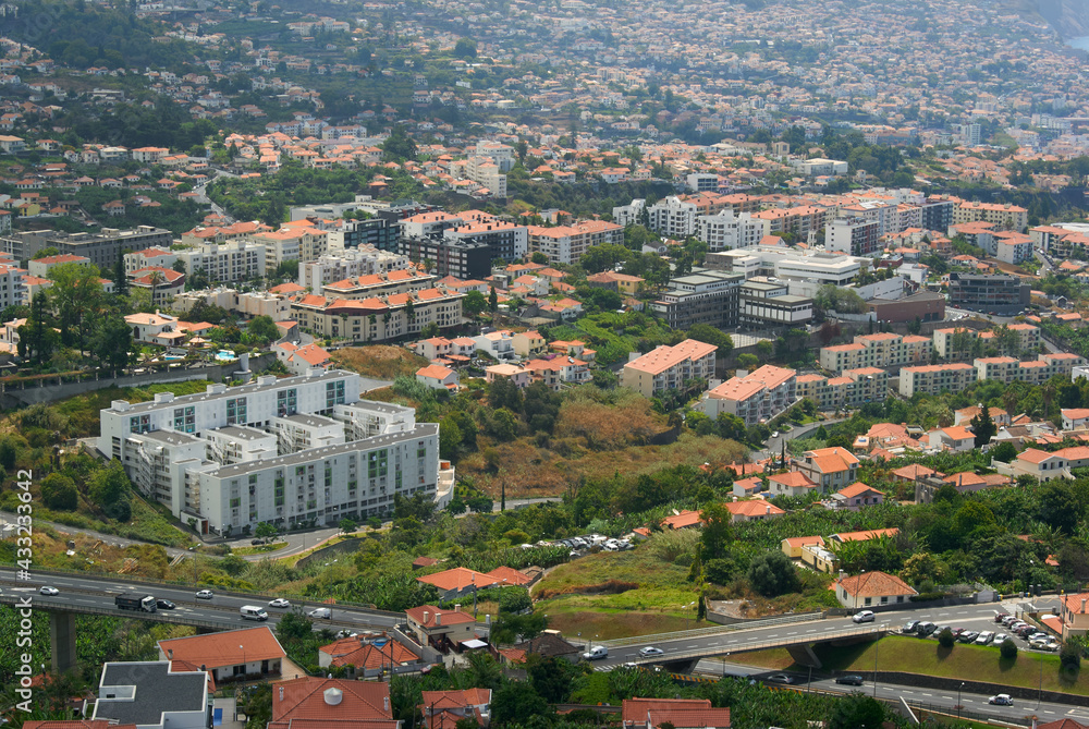 aerial view Funchal landscape, travel destination city, Madeira Island with buildings integrated in nature, sustainable green city