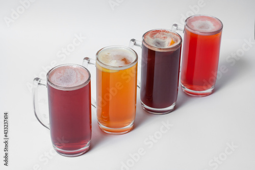 craft and colored beer set in mugs isolated