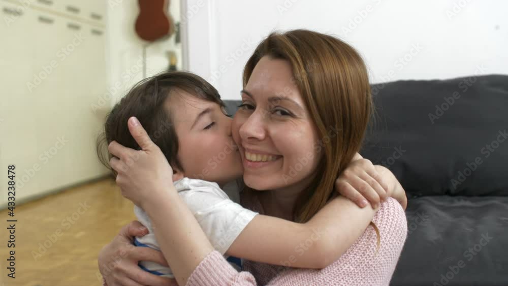 mother hugging and kissing with her son mother hugging and kissing with her son