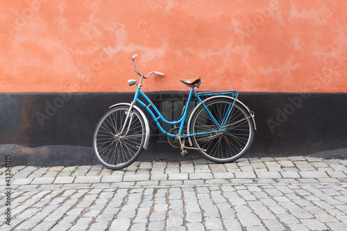 Photography A vintage bicycle against a wall on a cobbled street, Stockholm, Sweden