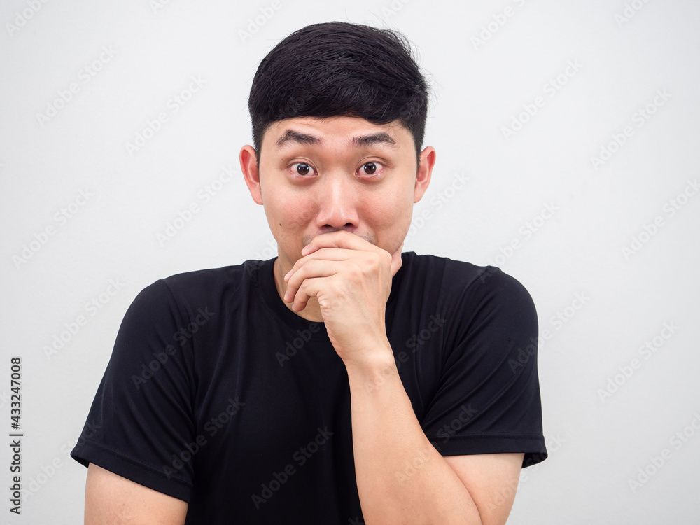 Closeup Asian man laugh but close his mouth by hand portrait on white isolated background Closeup Asian man laugh but close his mouth by hand portrait on white isolated background