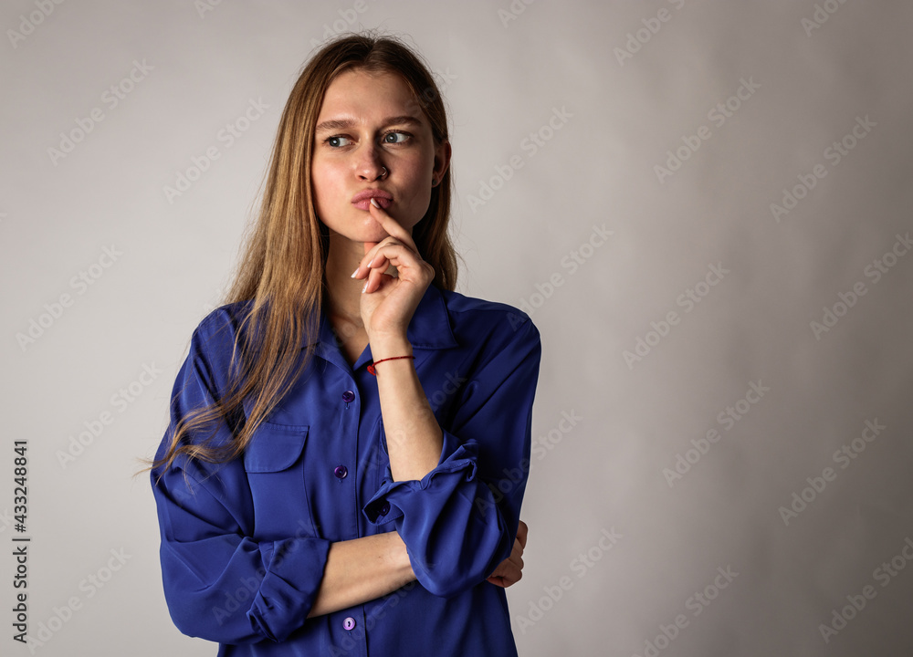 Young woman in blue full of doubts and hesitation. Young woman in blue full of doubts and hesitation.