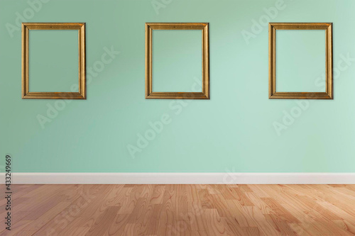empty green room with gold pictures frames © JuanP