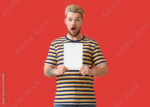 Surprised young man with ta...