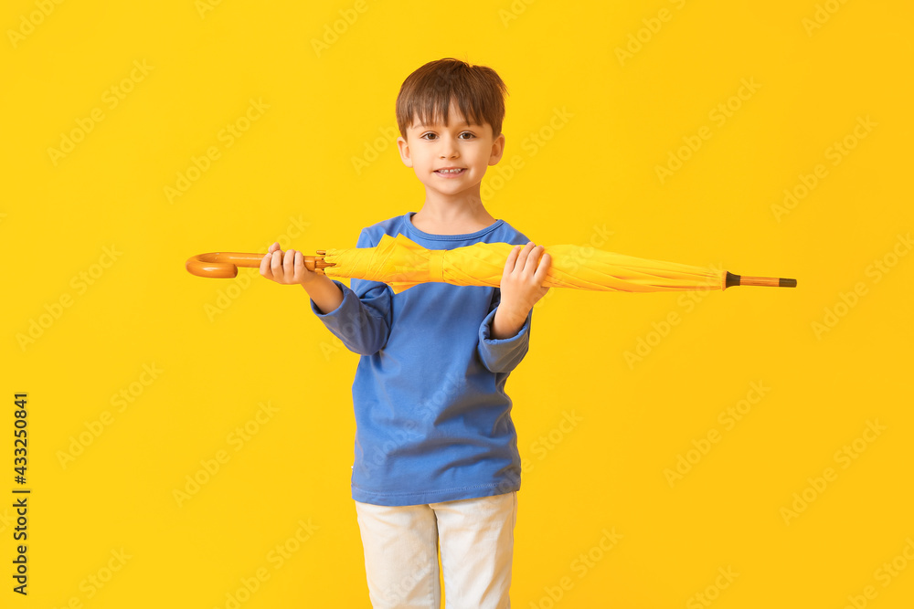 Cute little boy with umbrella on color background Cute little boy with umbrella on color background