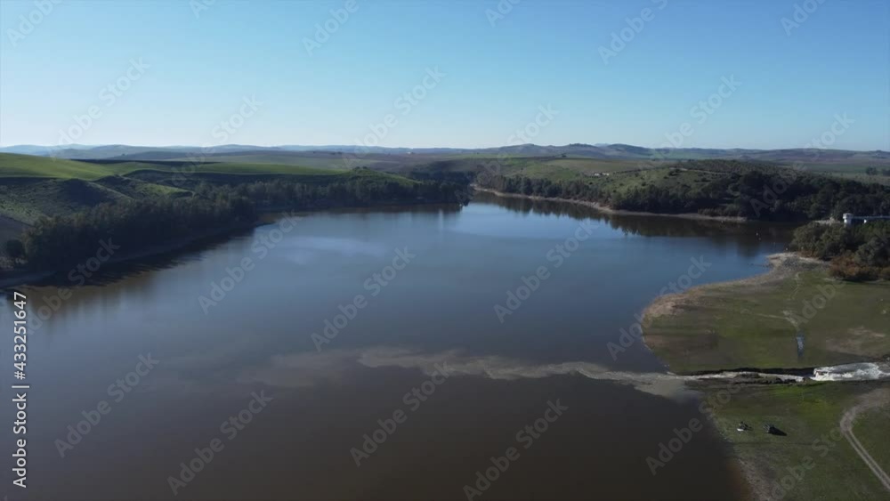 Aerial drone shot flying at high altitude over polluted lake in countryside nature Aerial drone shot flying at high altitude over polluted lake in countryside nature