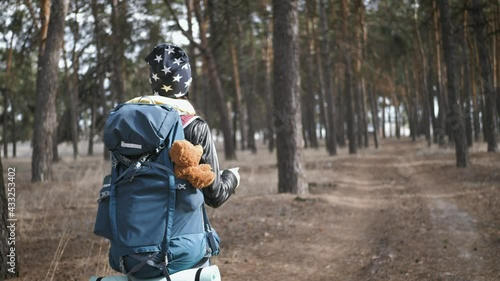 Wallpaper Mural Young woman hiking nature in pine forest. Happy tourist with backpack on forest pine trees. Hipster woman hiker in forest a park. Adventure travel ecotourism concept. Lifestyle travel in nature. Torontodigital.ca