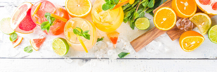 Summer cold drinks, fruit lemonade sangria cocktail, infused beverages with various citrus - orange, lemon, grapefruit, lime, with fresh fruits copy space