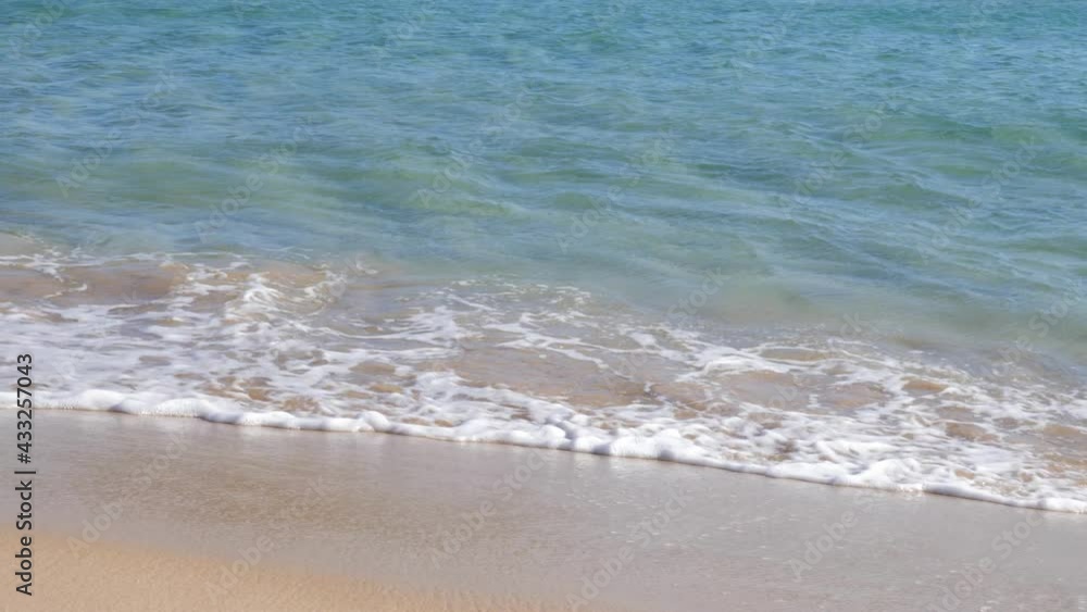 Slow motion shot of calm turquoise water hitting sandy beach on seashore in Southern Sardinia, Italy Slow motion shot of calm turquoise water hitting sandy beach on seashore in Southern Sardinia, Italy