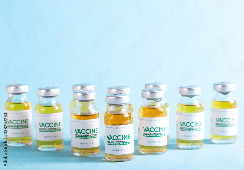 Vials with a new modern medicine for coronavirus on a blue background in the laboratory. Copy space for text, SARS-Cov-2 Vials with a new modern medicine for coronavirus on a blue background in the laboratory. Copy space for text, SARS-Cov-2