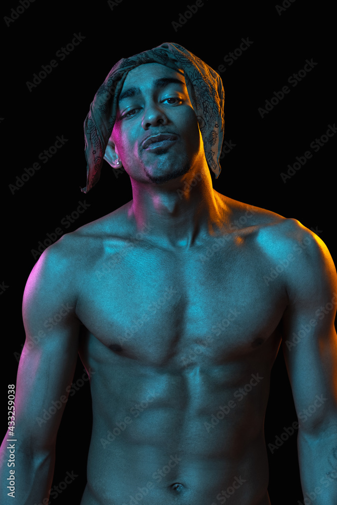 African-american young man's portrait on black studio background in neon. Concept of fashion, man's beauty, youth culture, performance. African-american young man's portrait on black studio background in neon. Concept of fashion, man's beauty, youth culture, performance.