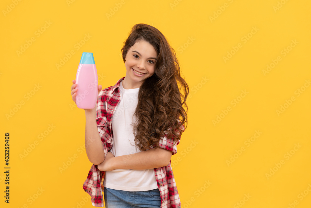 happy teen girl with long curly hair hold shampoo bottle, haircare happy teen girl with long curly hair hold shampoo bottle, haircare