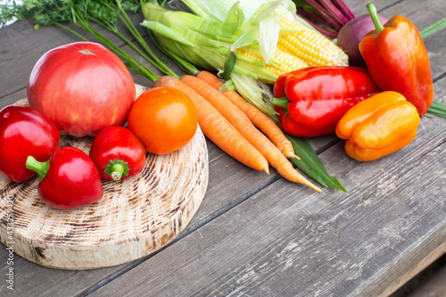 Summer harvest on a wooden table. Assortment of vegetables carrots and tomatoes, bell peppers and beets. Copy space for text, farming photo