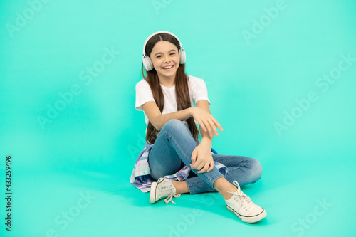 nice smile. online education. back to school. happy teen girl in headphones. listen to music.