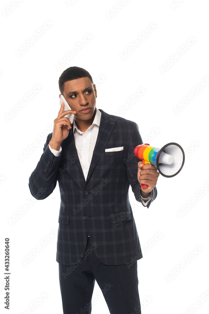 african american businessman talking on smartphone while holding lgbt colors megaphone isolated on white african american businessman talking on smartphone while holding lgbt colors megaphone isolated on white