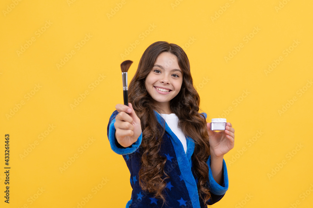 skincare and makeup. concept of natural beauty. happy teen girl hold powder brush. kid cosmetology skincare and makeup. concept of natural beauty. happy teen girl hold powder brush. kid cosmetology