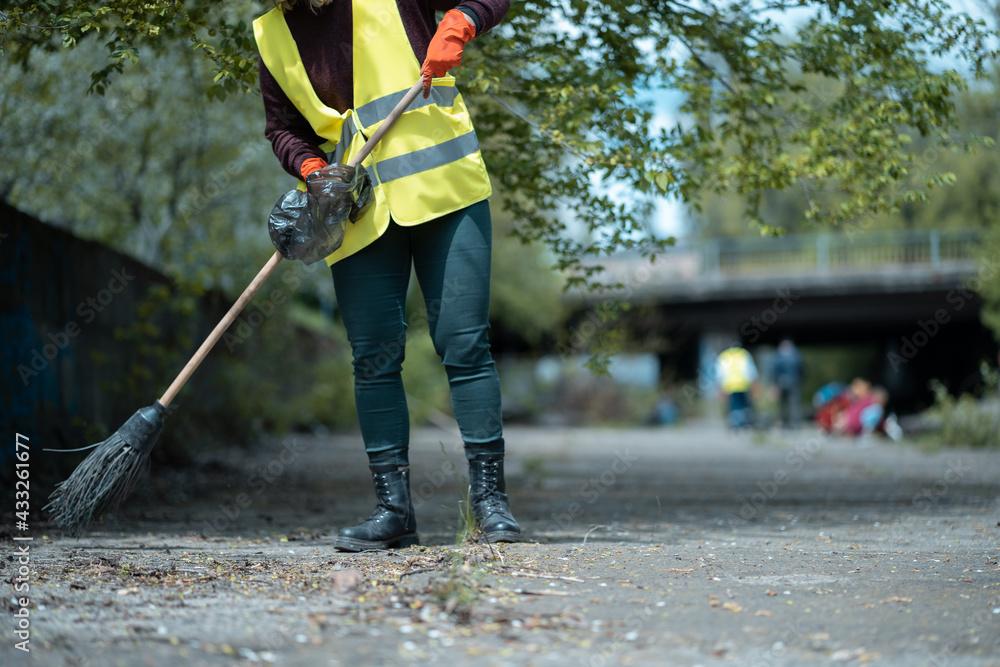 pretty volunteer female cleaning up park from dust waste and foliage pretty volunteer female cleaning up park from dust waste and foliage
