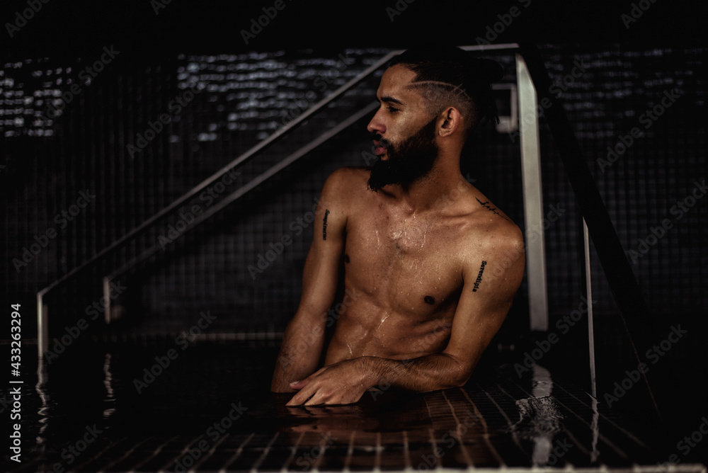 Male model posing in a swimming pool Male model posing in a swimming pool