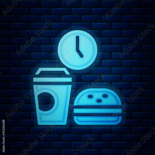 Glowing neon Fast food time icon isolated on brick wall background. Vector