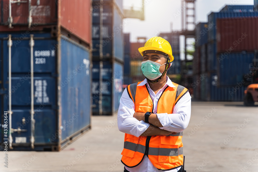 Workers waring surgical mask and safety white head to protect for pollution and virus in workplace during concern about covid pandemic Workers waring surgical mask and safety white head to protect for pollution and virus in workplace during concern about covid pandemic