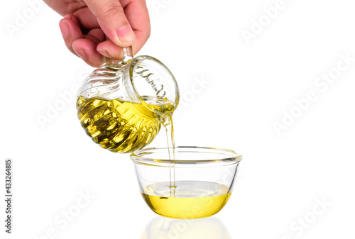 Chef is pouring natural organic vegetable oil made from flax seeds, sunflower, nuts, sesame and rice separately on white background. photo