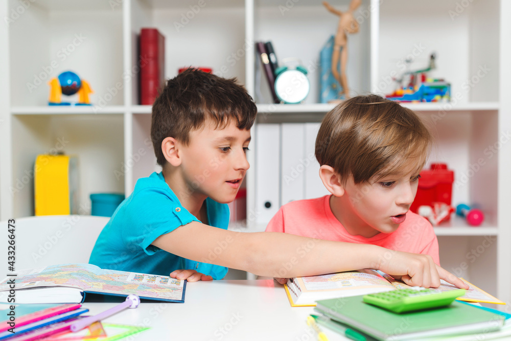 Back to school concept. Cute industrious children are sitting at the desk. Kids are learning in class. Back to school concept. Cute industrious children are sitting at the desk. Kids are learning in class.