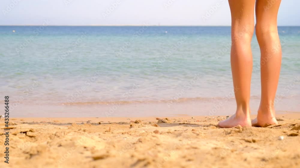 The child stands on the seashore. Selective focus. The child stands on the seashore. Selective focus.
