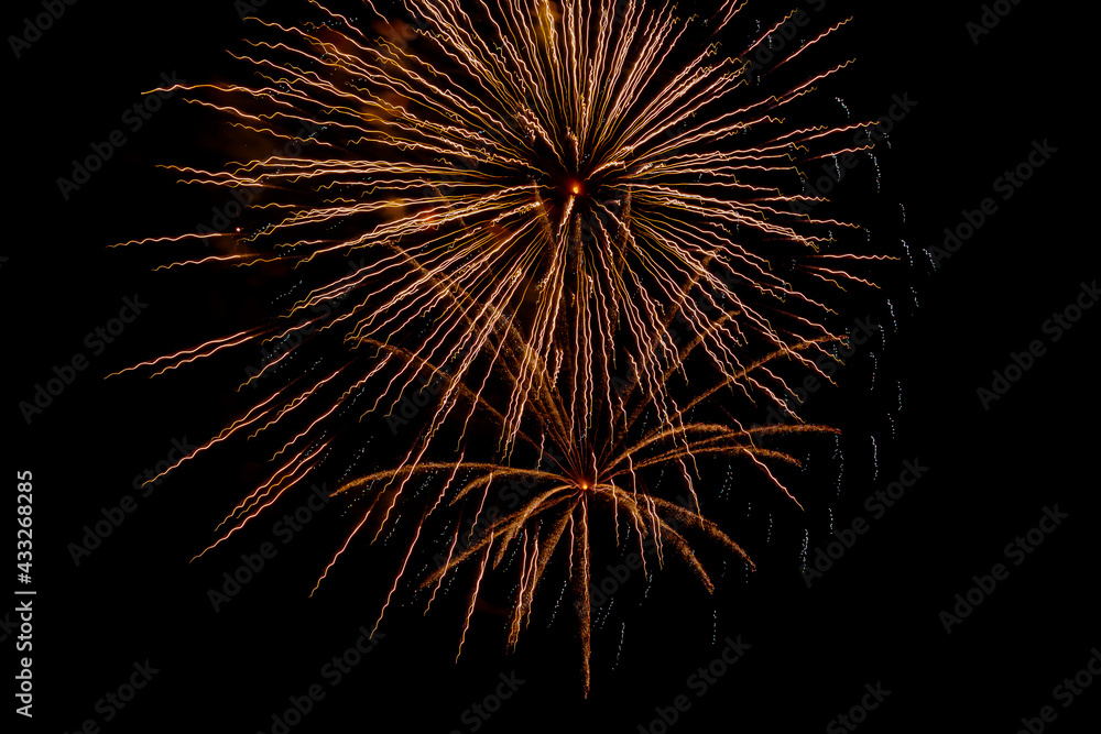 Bright festive fireworks against the night sky. Firework Fiery flowers during the holiday.