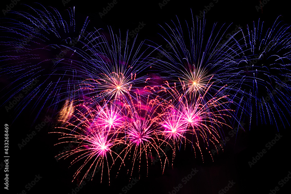 Bright festive fireworks against the night sky. Firework Fiery flowers during the holiday.