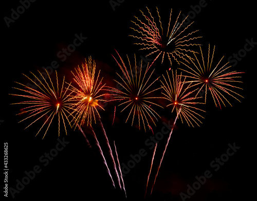 Bright festive fireworks against the night sky. Firework Fiery flowers during the holiday.