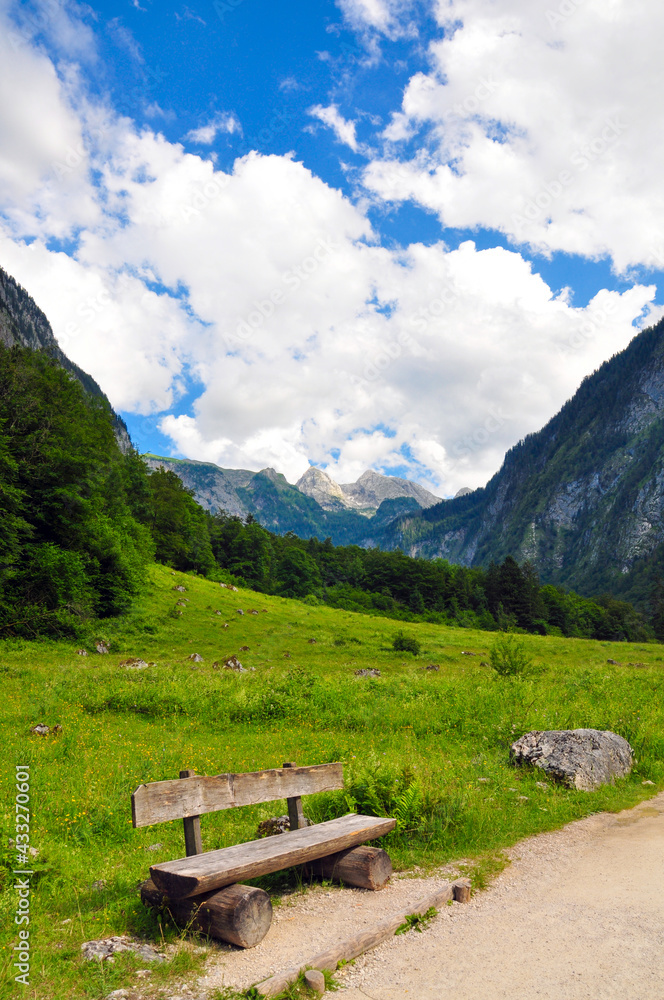 Wooden bench on the road to the Obersee, near the Königssee, German. Bavarian alps. Wooden bench on the road to the Obersee, near the Königssee, German. Bavarian alps.