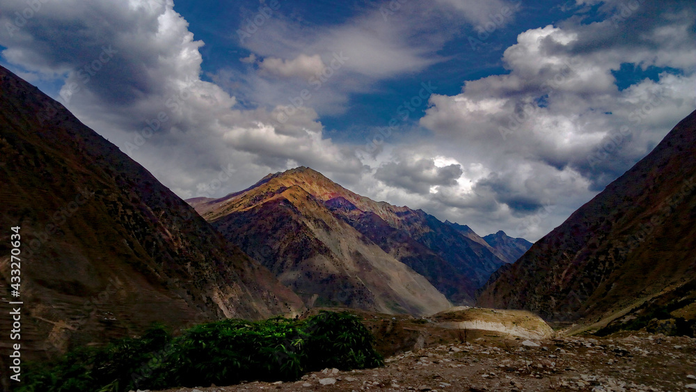 clouds over the mountains, beautiful mountains of Pakistan, blue sky with mountains, rocks, 