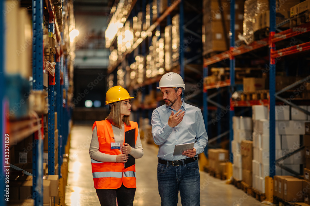 Warehouse staff meeting, worker with manger Warehouse staff meeting, worker with manger