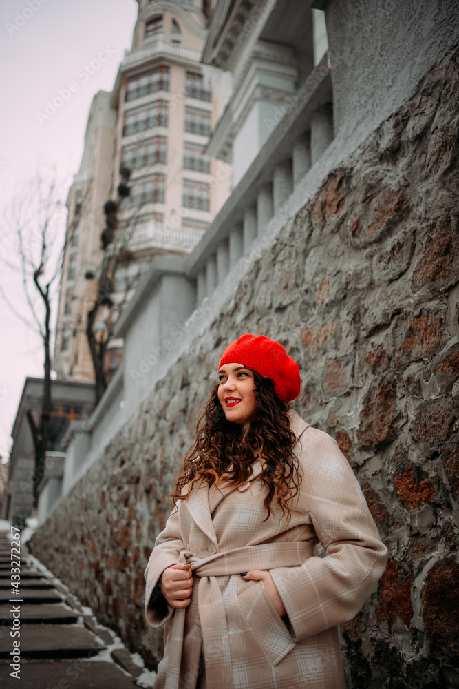 curvy girl with long curly hair in red beret