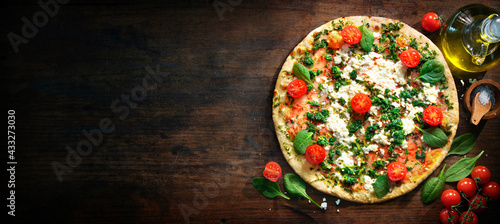 Crispy spinach pizza with ricotta, mozzarella and tomatoes