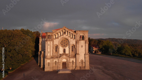 DRONE AERIAL VIEW: Facade of the church of Nossa Senhora da Assuncao (Our Lady of Assumption) in the hill of Monte Cordoba at sunset in Santo Tirso, Portugal. photo