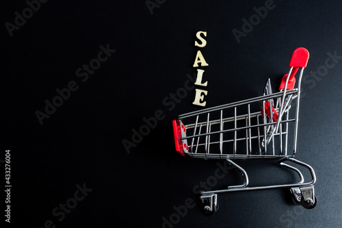 Discount sale. Large letters sale, action. Wooden letters discount on black background.