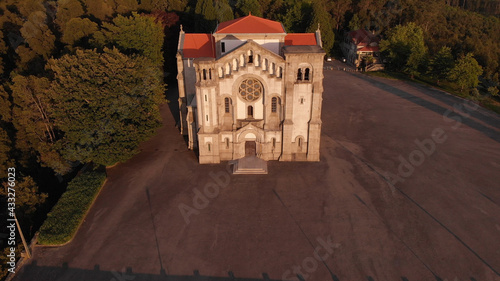 DRONE AERIAL VIEW: Facade of the church of Nossa Senhora da Assuncao (Our Lady of Assumption) in the hill of Monte Cordoba at sunset in Santo Tirso, Portugal. photo