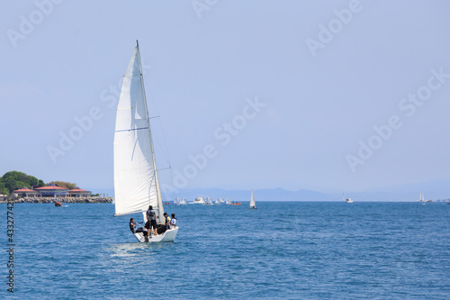 white sailing boat on the sea. Front view