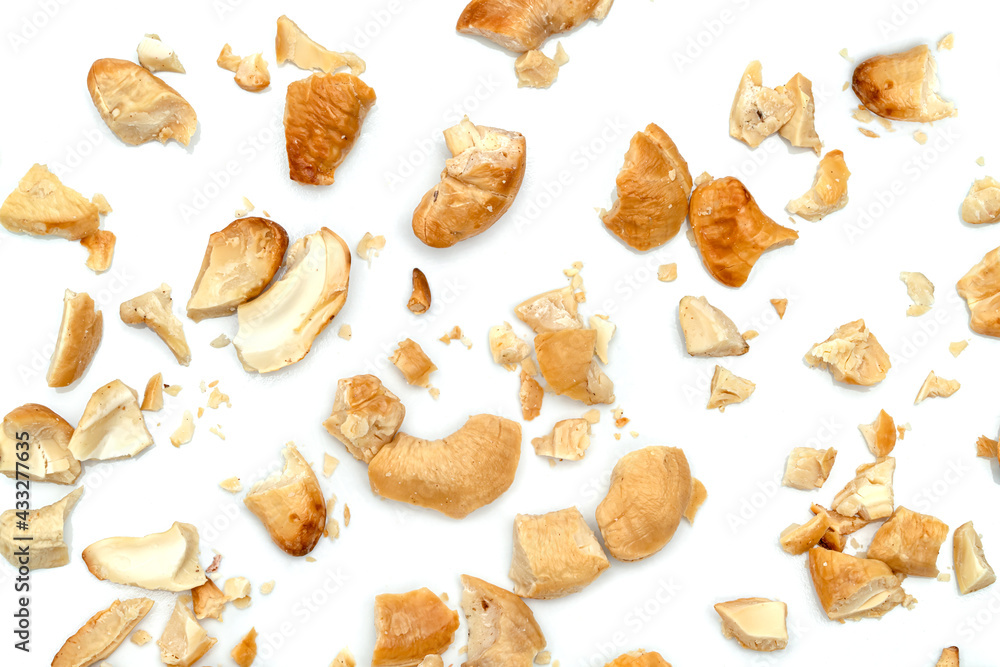 Fototapeta premium broken roasted cashew nuts isolated on white background