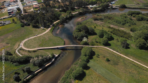 DRONE AERIAL VIEW: Rio Neiva Bridge - Ecovia Litoral Norte (North Coast Ecoway). Pedestrian, cycle bridge over the Neiva river in Antas, Esposende, Portugal. photo