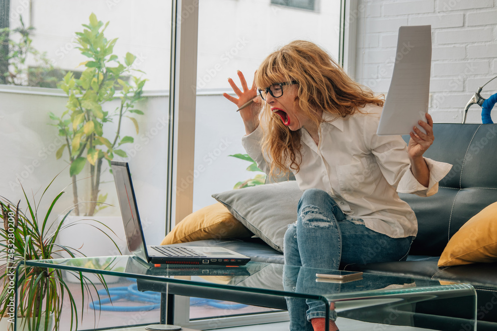 angry woman at home with computer angry woman at home with computer