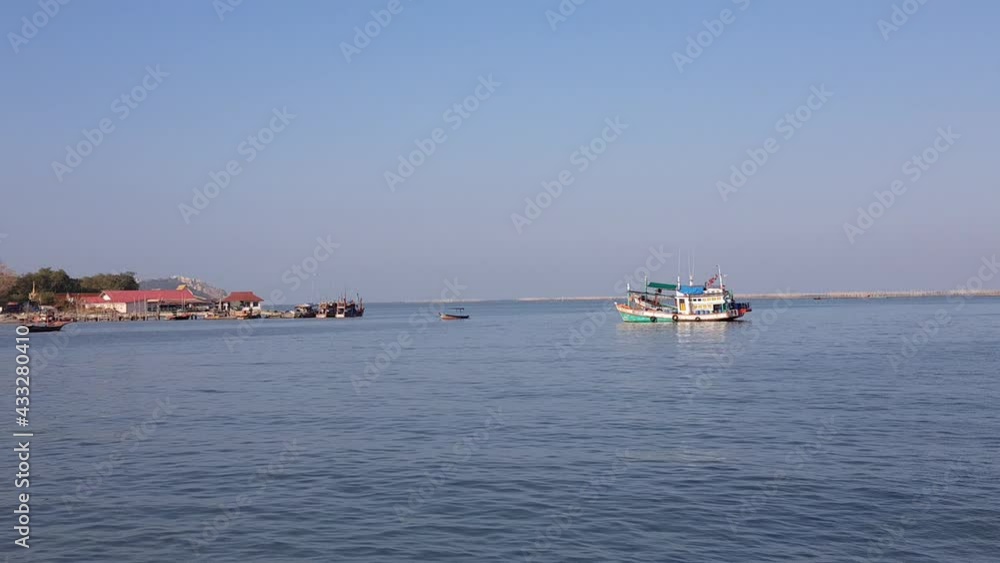 The sea with fishing boats anchored by the shore The sea with fishing boats anchored by the shore