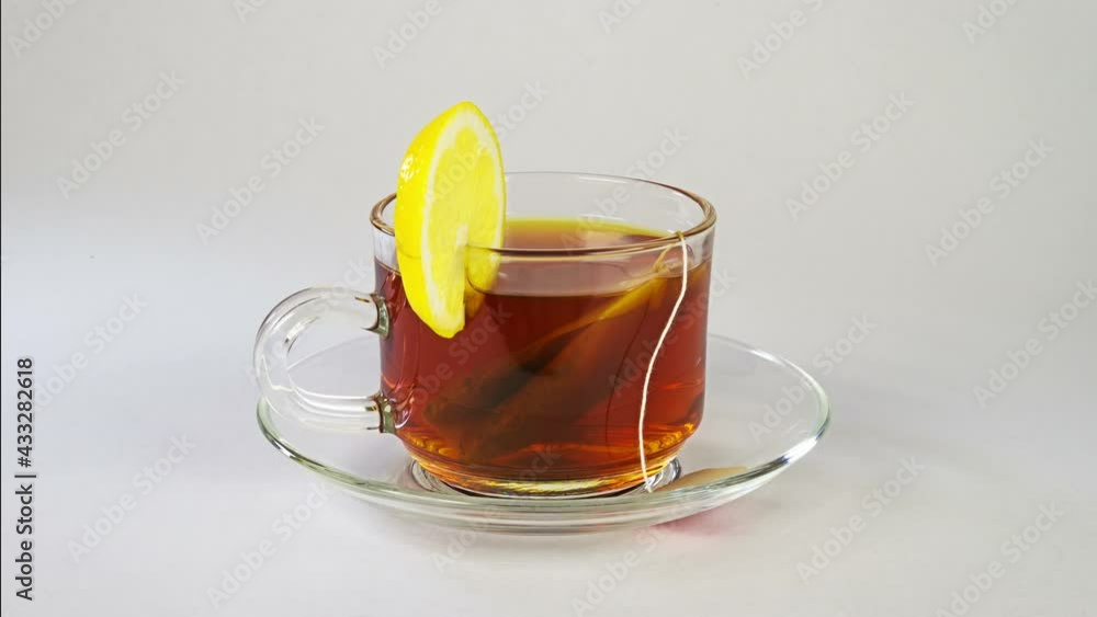 Cup of tea with lemon rotation on the white background 4K Cup of tea with lemon rotation on the white background 4K
