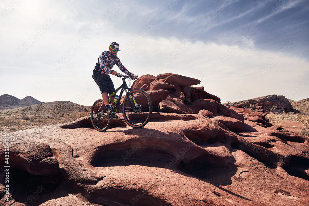 Fototapeta premium Mountain biker rides at the desert scenic in Kazakhstan