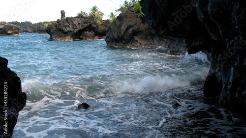 waves crashing into a cave on the beach