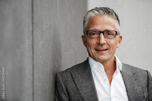 Smiling male investor with eyeglasses